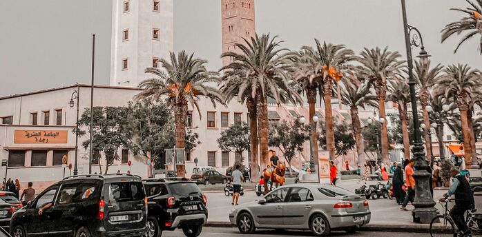 Street view with Oujda’s clock tower and busy city traffic