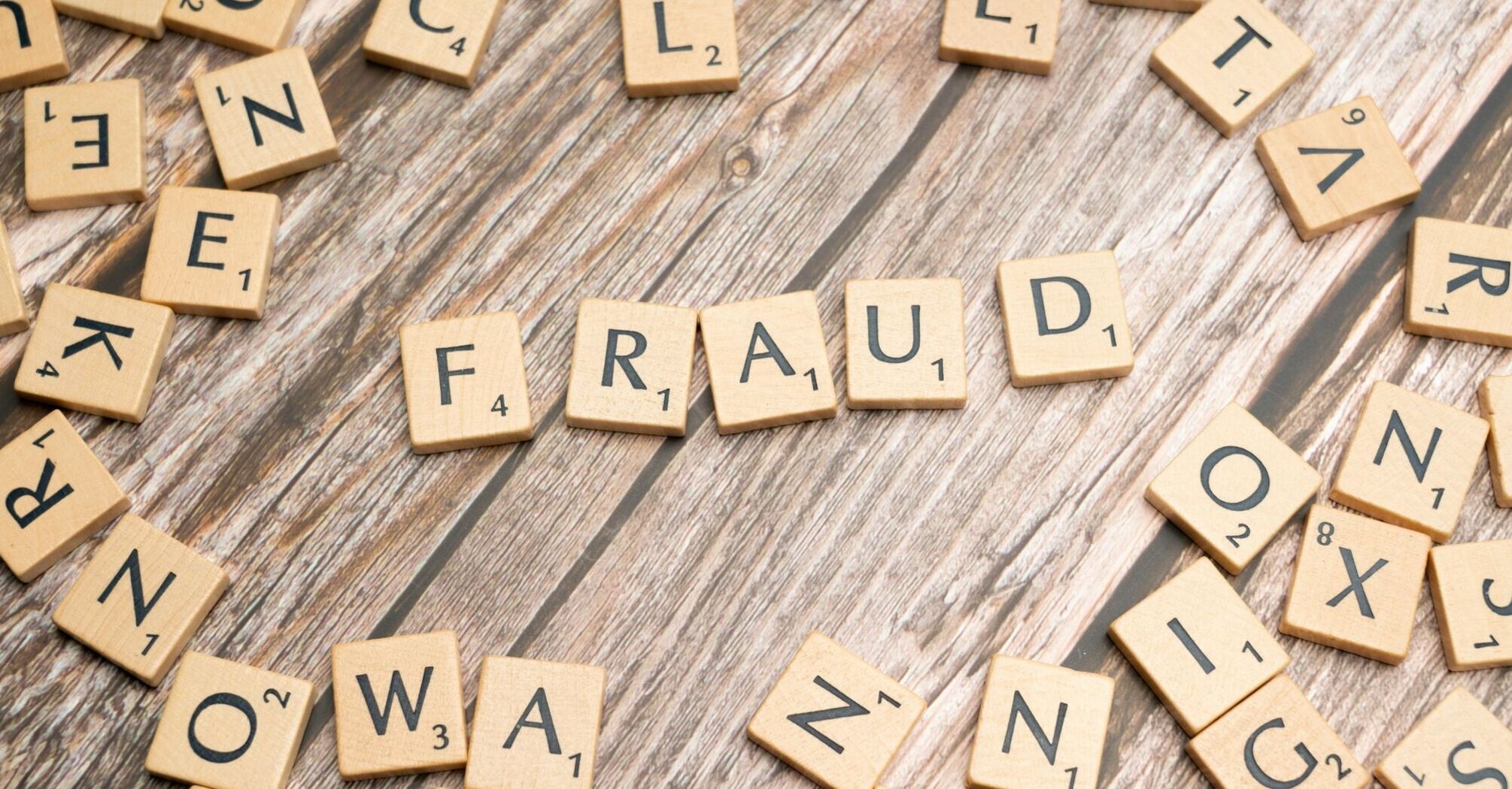 Scrabble tiles forming the word fraud