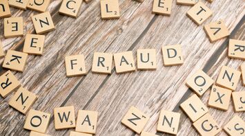 Scrabble tiles forming the word fraud
