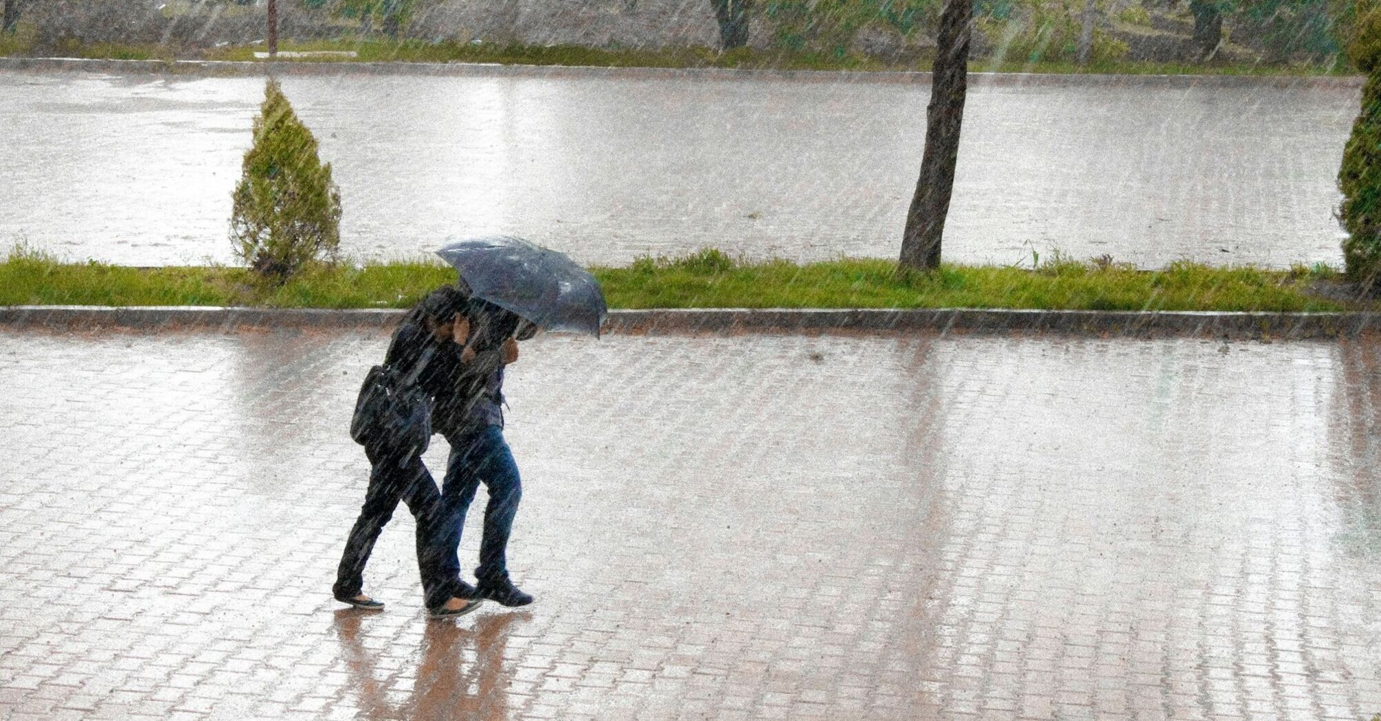 Pedestrians walking in heavy rain during stormy weather