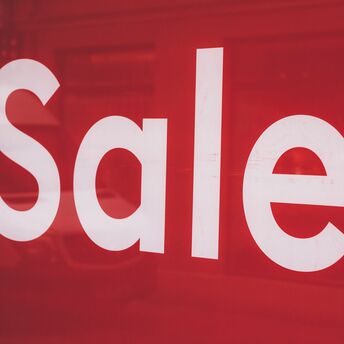 Red sale signage in shop window