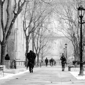 People walking during snowfall on a city street