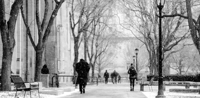People walking during snowfall on a city street