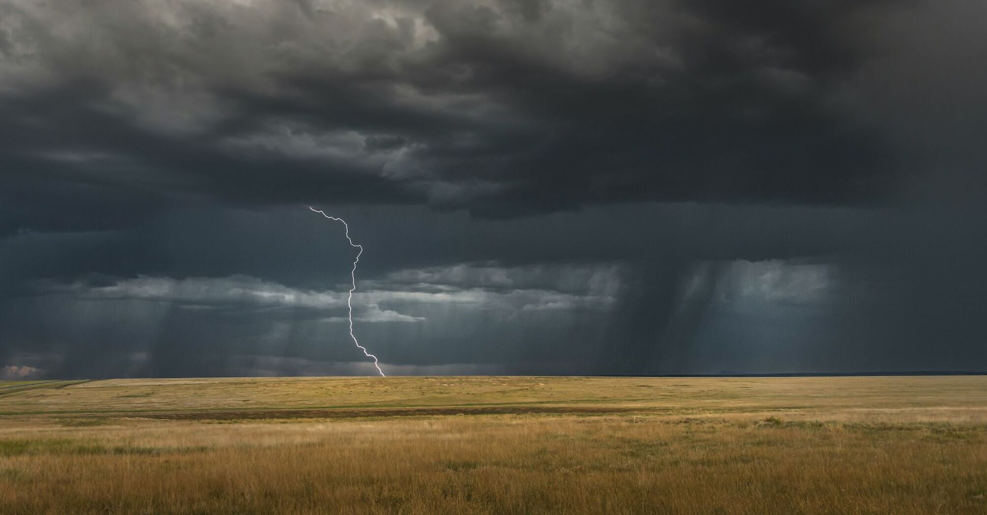 Lightning strike under dark storm clouds