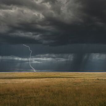 Lightning strike under dark storm clouds