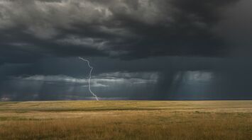 Lightning strike under dark storm clouds
