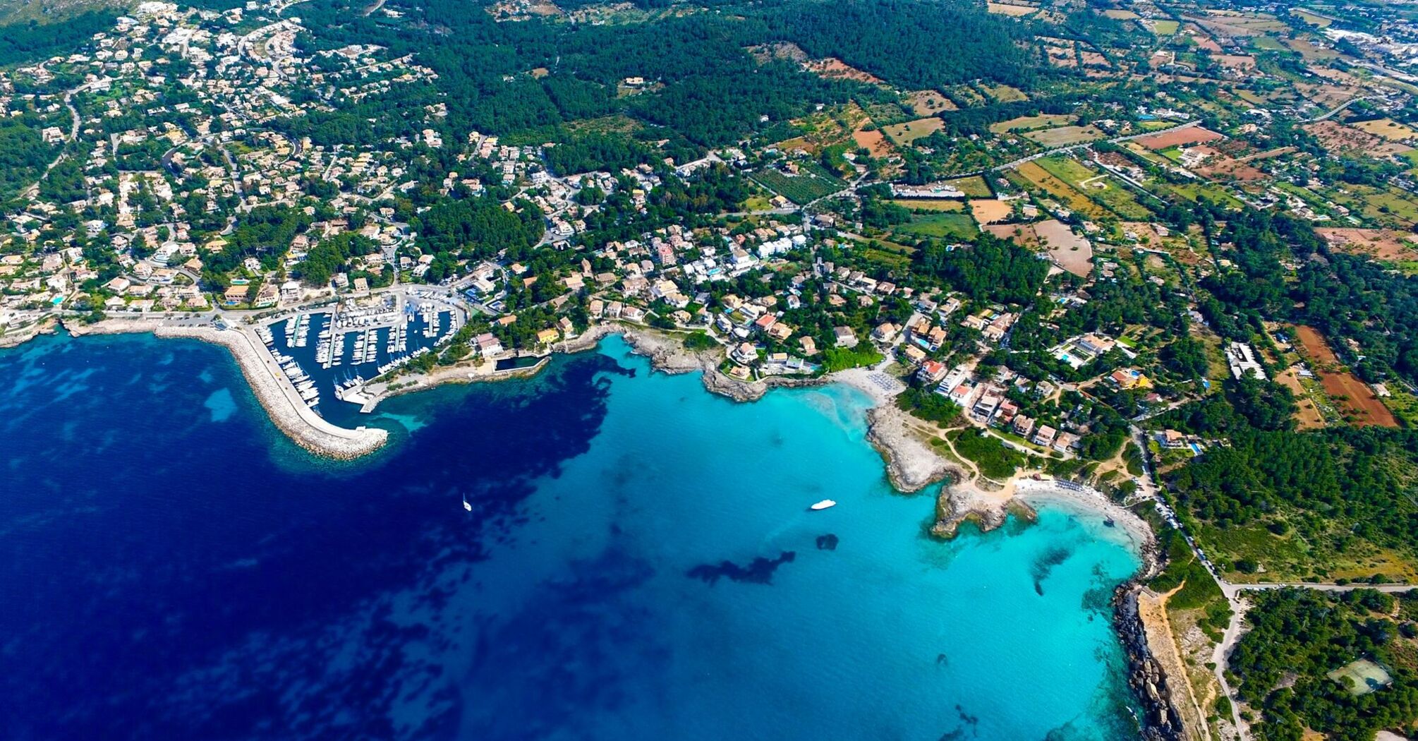 Aerial view of Mallorca’s coastline with turquoise bays and towns