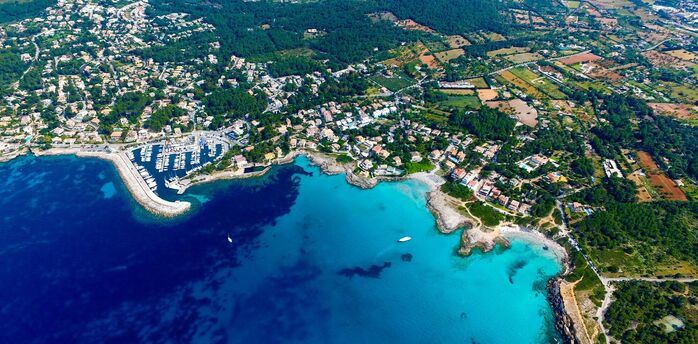 Aerial view of Mallorca’s coastline with turquoise bays and towns