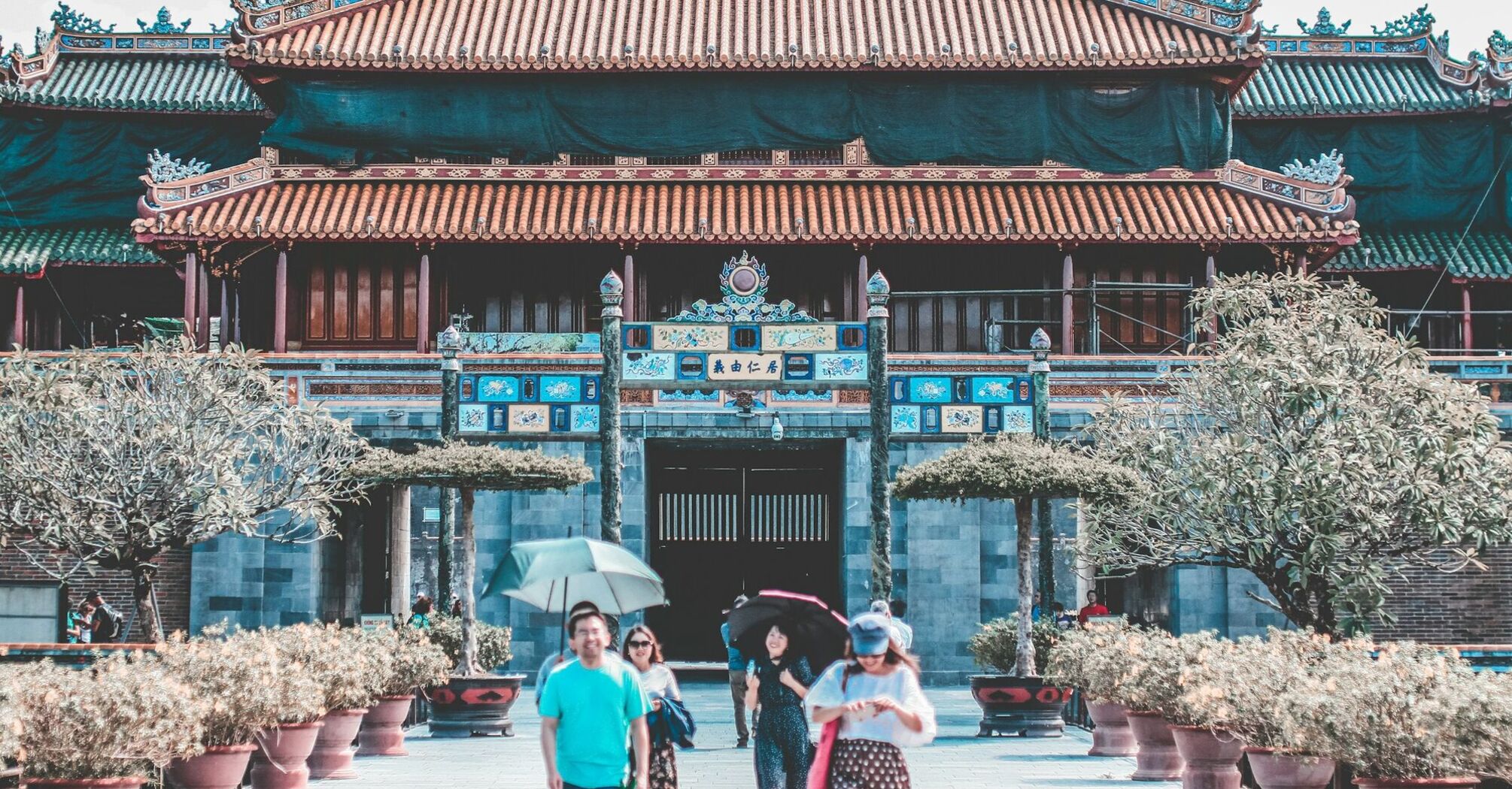 Traditional Chinese palace complex with visitors