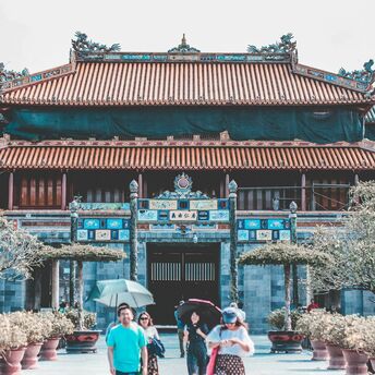 Traditional Chinese palace complex with visitors