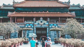 Traditional Chinese palace complex with visitors