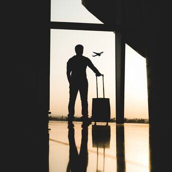 Traveller with suitcase at airport terminal