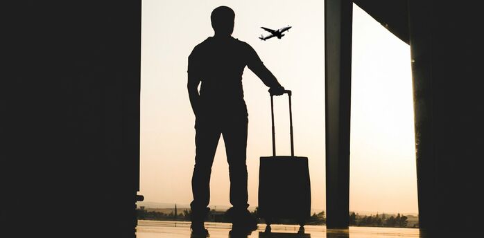 Traveller with suitcase at airport terminal