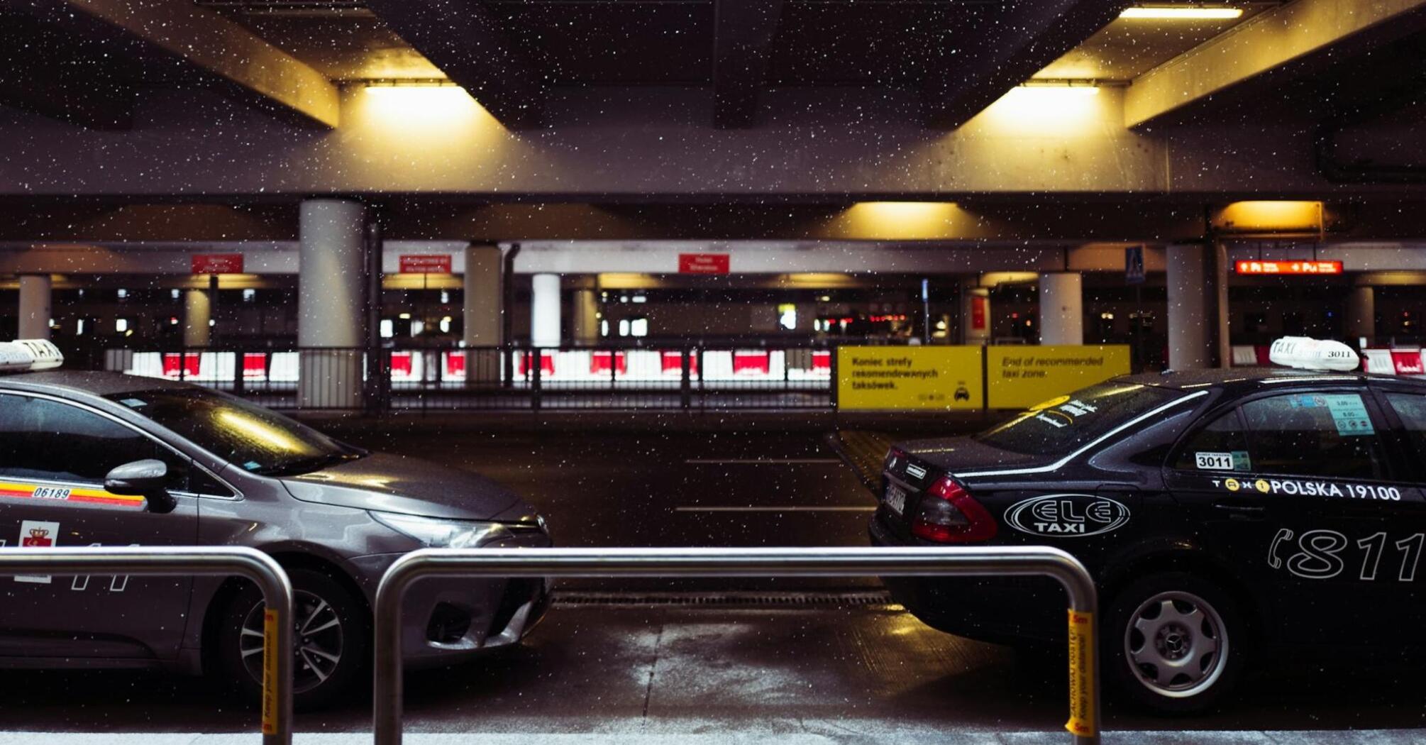 Vehicles at airport drop-off area during winter weather