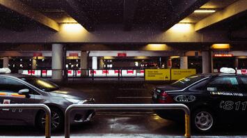 Vehicles at airport drop-off area during winter weather