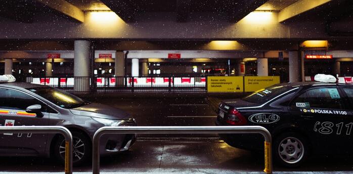 Vehicles at airport drop-off area during winter weather