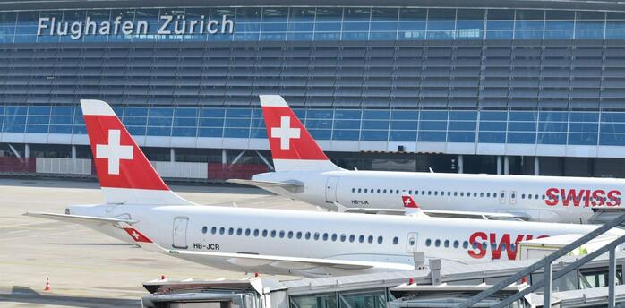 SWISS aircraft parked at Zurich Airport terminal