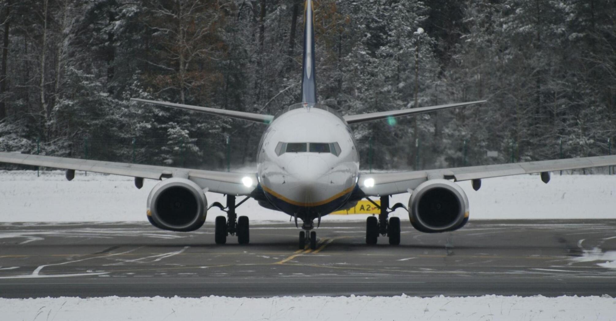 Commercial aircraft on runway during winter conditions