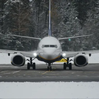 Commercial aircraft on runway during winter conditions