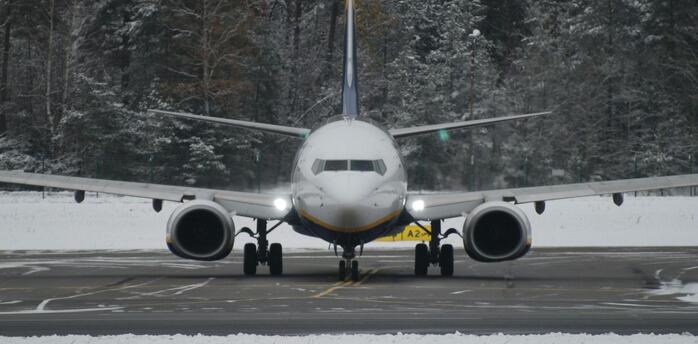 Commercial aircraft on runway during winter conditions