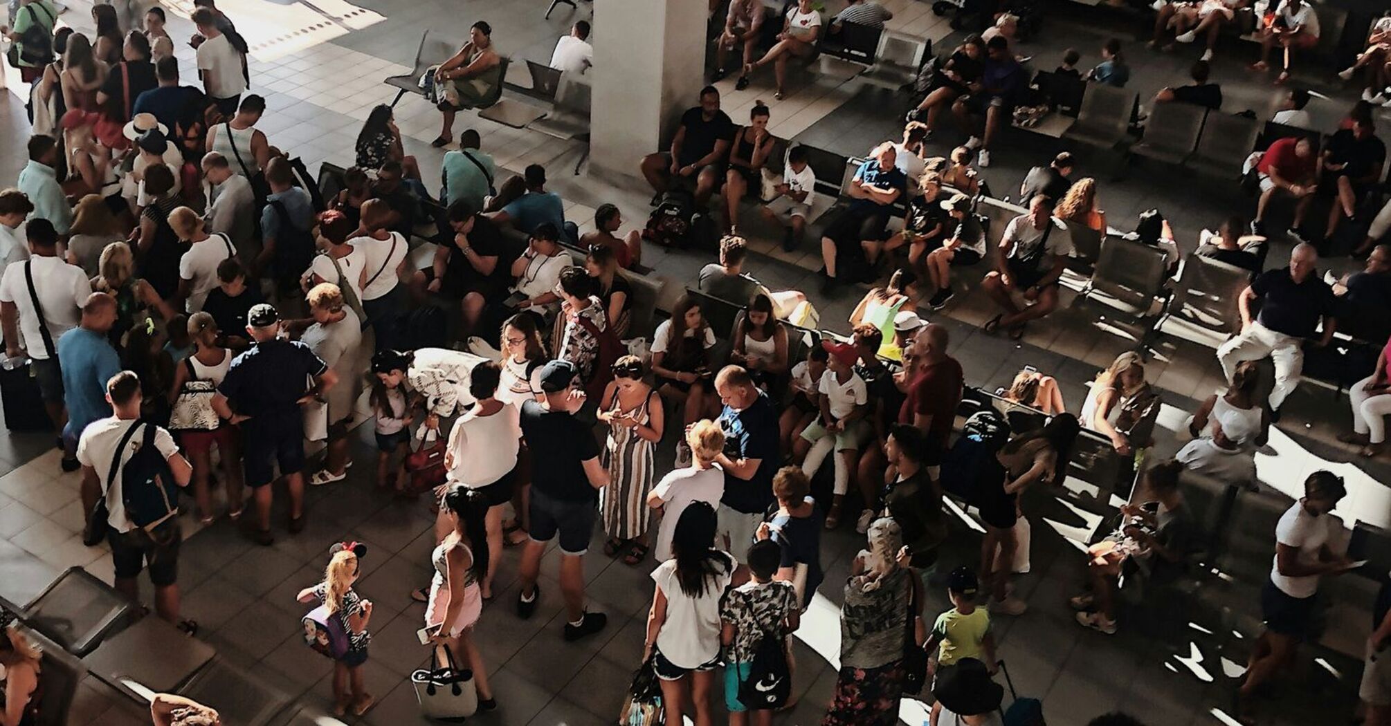 Crowded airport terminal during flight disruption