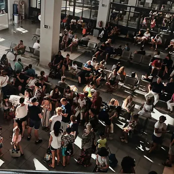 Crowded airport terminal during flight disruption