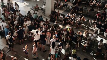 Crowded airport terminal during flight disruption