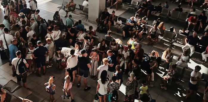 Crowded airport terminal during flight disruption
