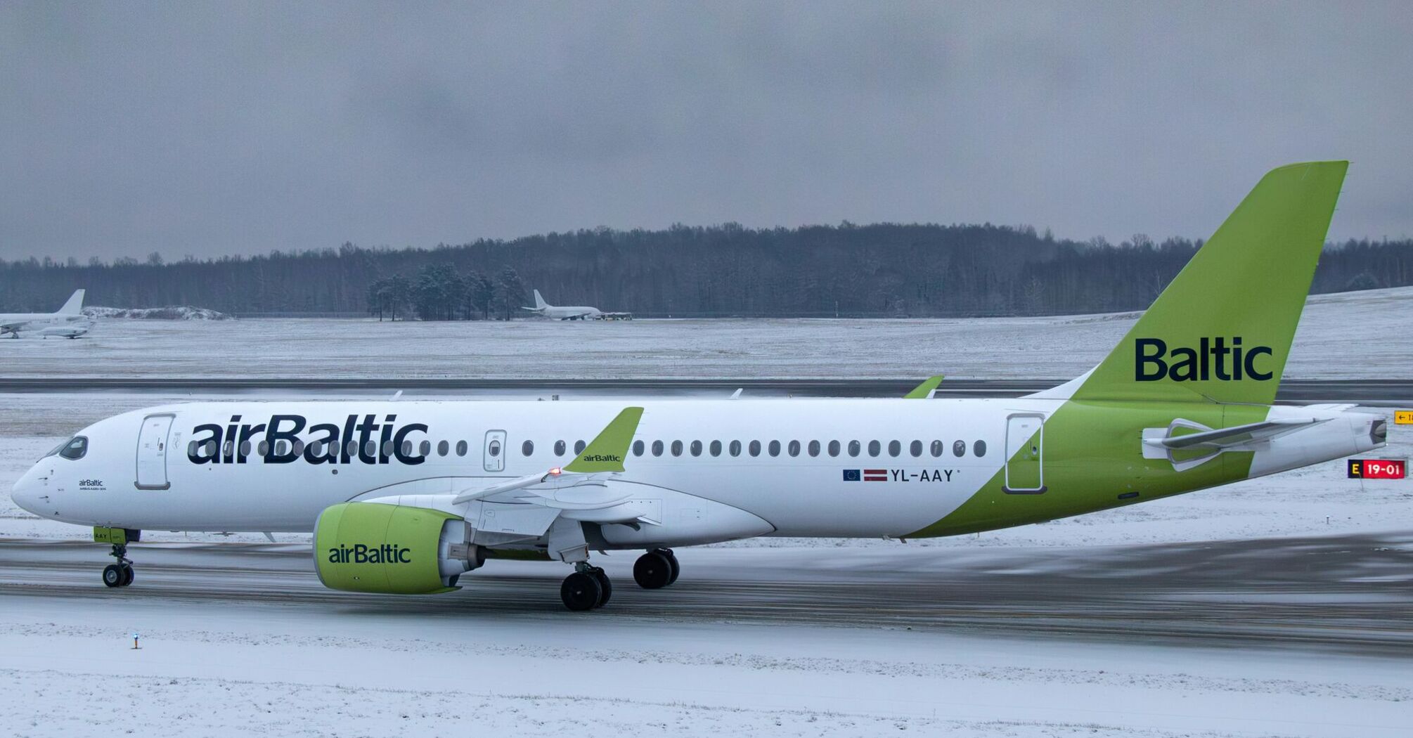 airBaltic aircraft taxiing during winter operations in the Baltics