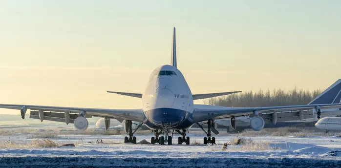 Aircraft standing on a snow-covered airport runway