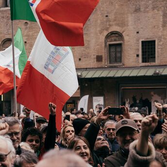 Crowd holding Italian flags during a national strike.