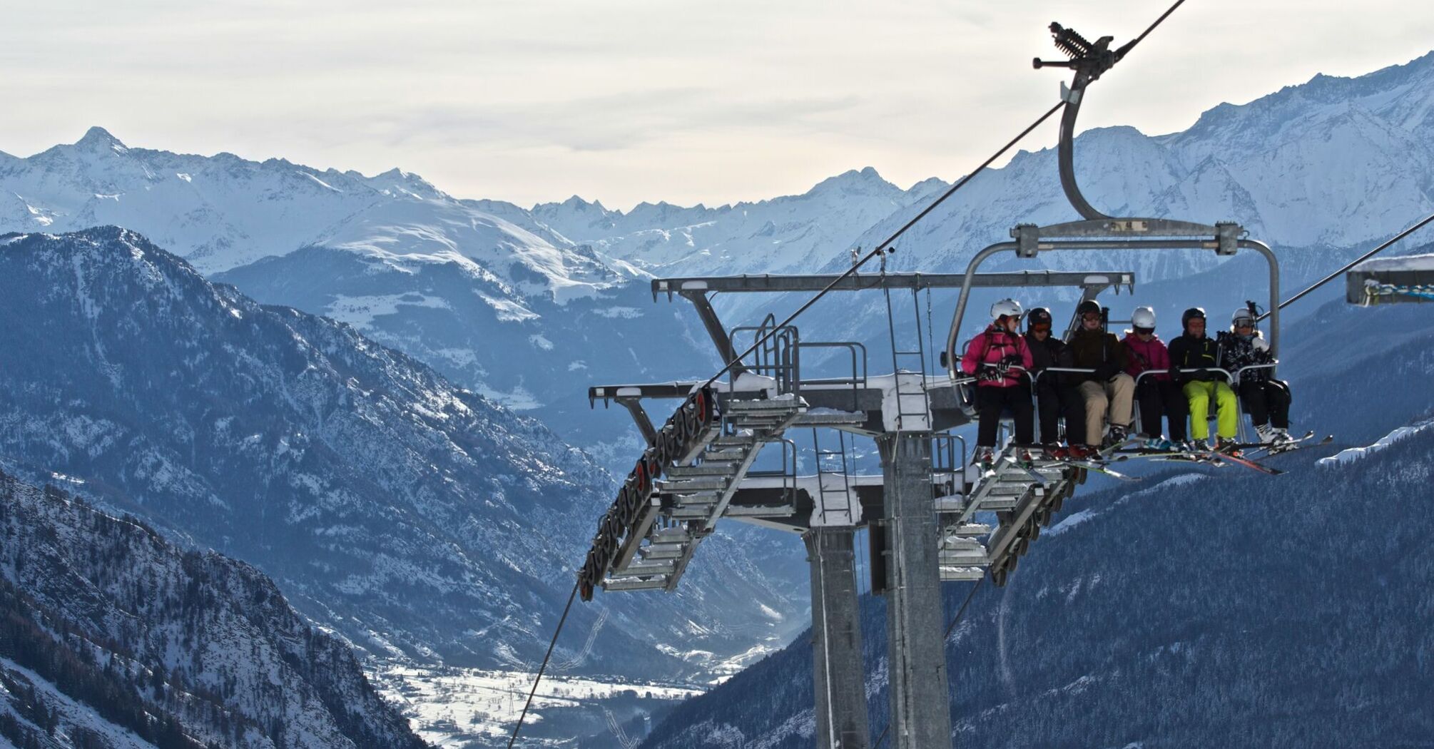 Ski lift operating above alpine mountain valley