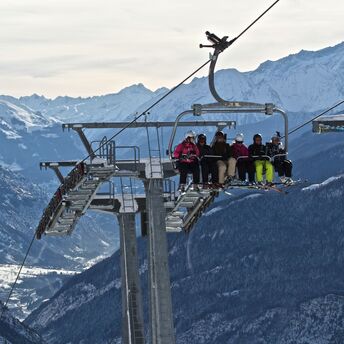 Ski lift operating above alpine mountain valley