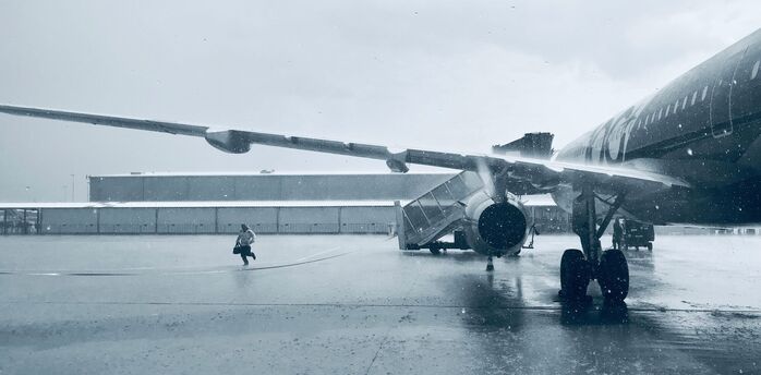 Aircraft on a snowy apron during winter weather disruption
