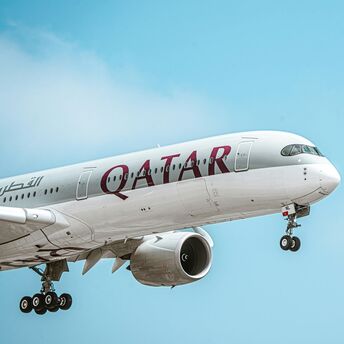 Qatar Airways Airbus aircraft climbing after take-off under clear sky