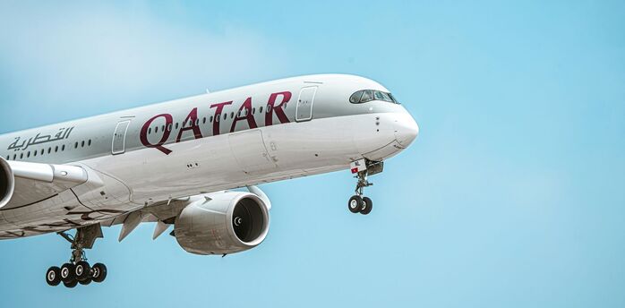 Qatar Airways Airbus aircraft climbing after take-off under clear sky