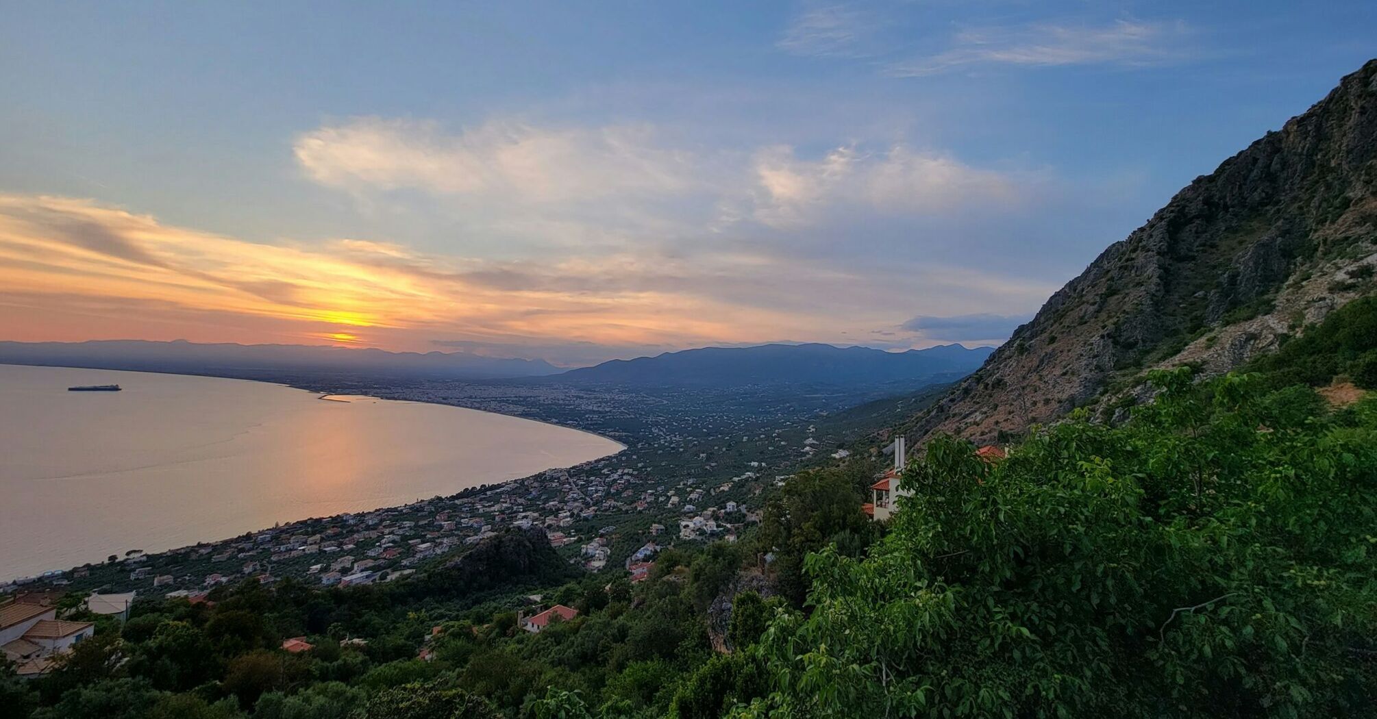 Coastal view of Kalamata at sunset with mountains and sea