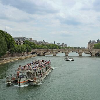 Sightseeing boat passing a bridge in Paris