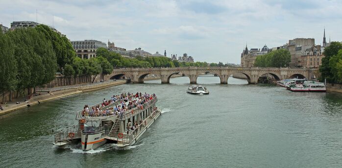 Sightseeing boat passing a bridge in Paris