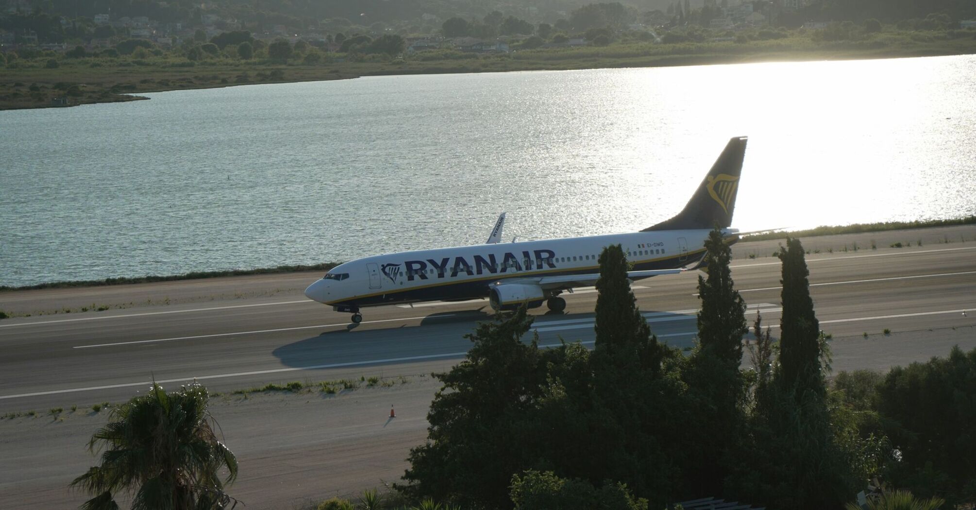 Ryanair aircraft taxiing beside a coastal runway