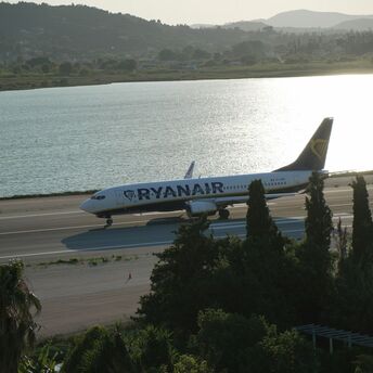Ryanair aircraft taxiing beside a coastal runway
