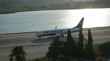Ryanair aircraft taxiing beside a coastal runway