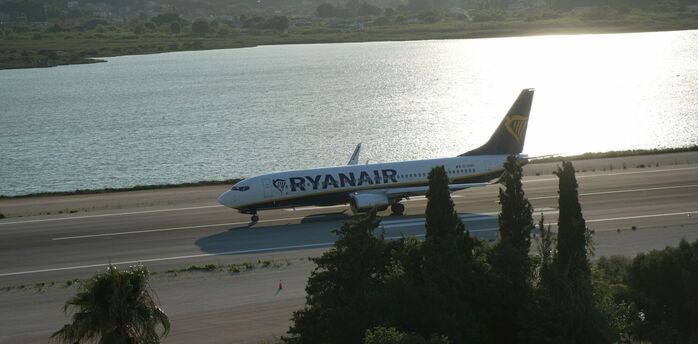 Ryanair aircraft taxiing beside a coastal runway