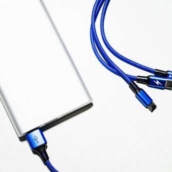 Silver power bank with blue charging cables