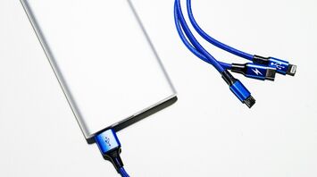 Silver power bank with blue charging cables