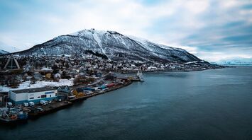Snow-covered mountain overlooking Tromsø's waterfront and harbour