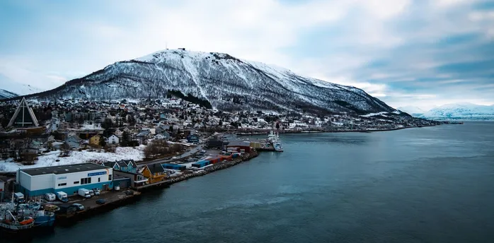 Snow-covered mountain overlooking Tromsø's waterfront and harbour