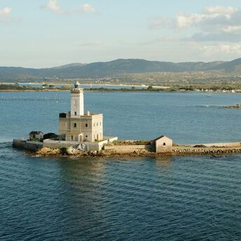 Stone lighthouse on a small island off the Sardinian coast