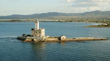 Stone lighthouse on a small island off the Sardinian coast