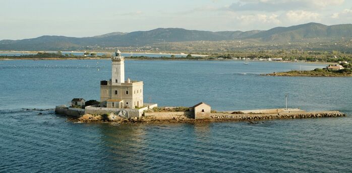 Stone lighthouse on a small island off the Sardinian coast